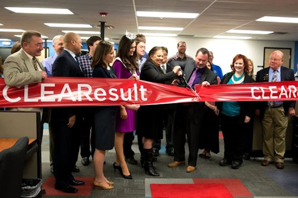 CustomerLink Vice President Frank Royal and Tempe Chamber of Commerce board member Mary Palomino cut the ribbon on the new CLEAResult call center in Tempe. The company hopes to create 200 jobs in Tempe by the end of 2015. (Photo by Andrew Ybanez)