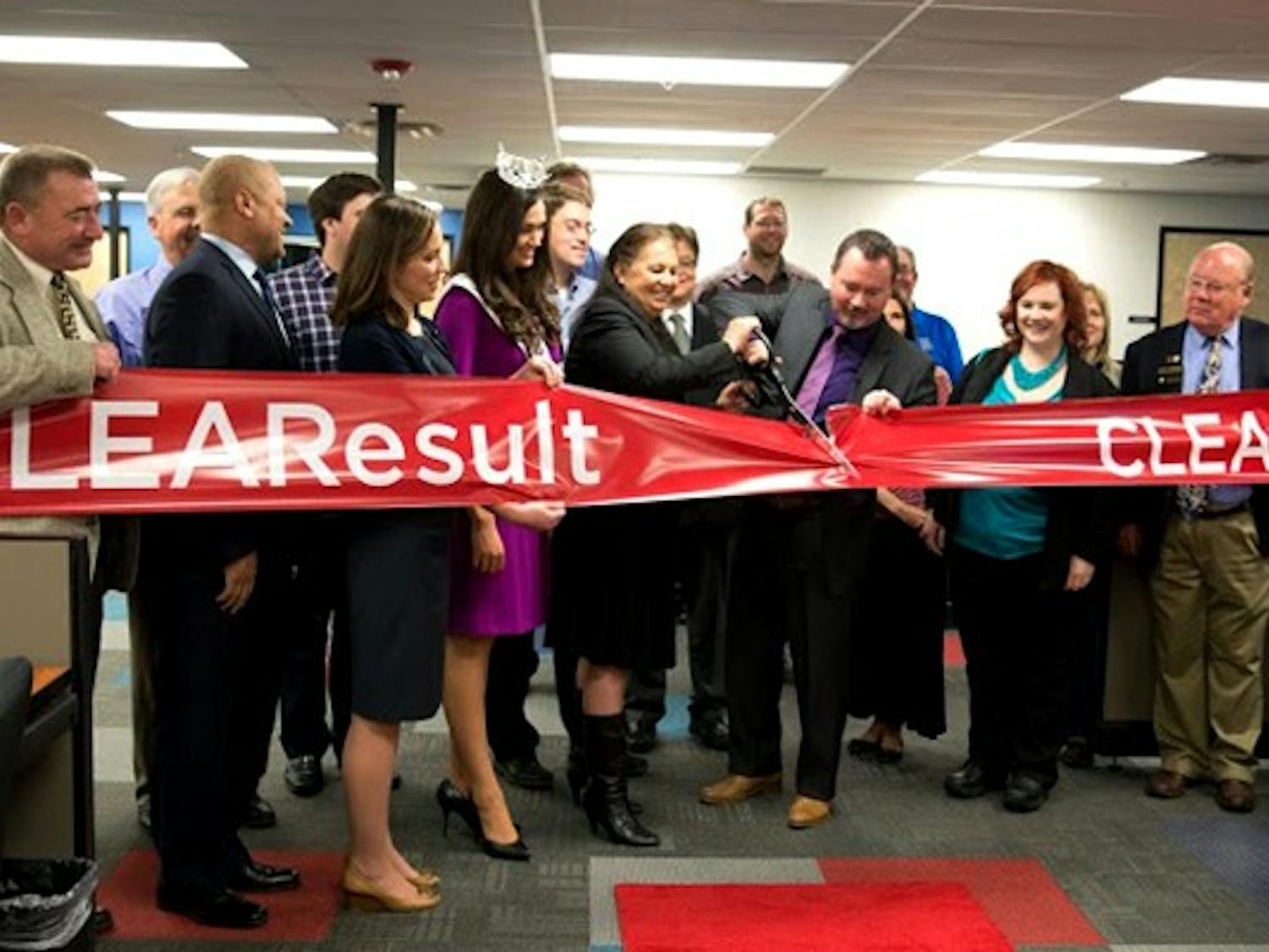 CustomerLink Vice President Frank Royal and Tempe Chamber of Commerce board member Mary Palomino cut the ribbon on the new CLEAResult call center in Tempe. The company hopes to create 200 jobs in Tempe by the end of 2015. (Photo by Andrew Ybanez)