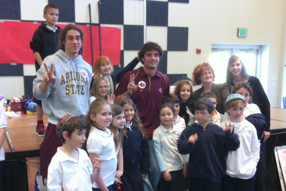 DOING A MITZVAH: Former ASU quarterback Samson Szakacsy and current ASU quarterback Brock Osweiler visited and spoke to the students at Jess Schwartz Academy in Scottsdale after a school-wide athletic equipment drive. (Photo by Harmony Huskinson)
