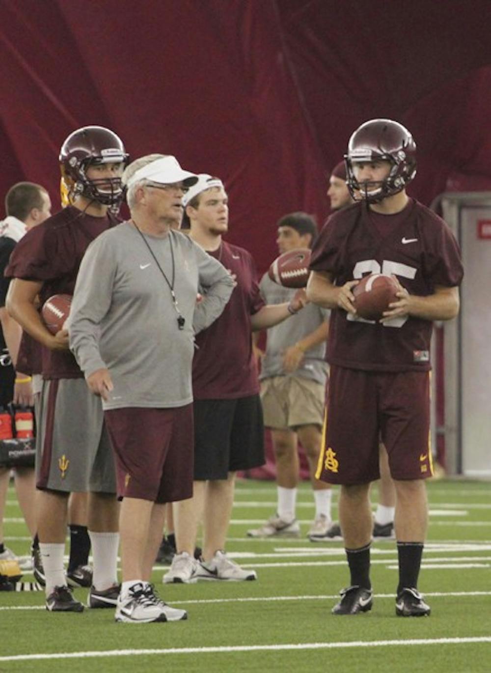 Shoes to fill: ASU redshirt freshman kicker Alex Garoutte talks to coach Dennis Erickson during practice on Wednesday. Garoutte has worked all summer and is ready to step into the kicking role filled last season by Thomas Weber. (Photo by Beth Easterbrook)