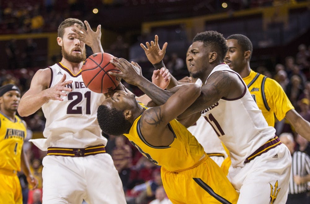 Junior forward Savon Goodman, right, fights for control of the ball in a game against Kennesaw State on Wednesday, Nov. 18, 2015, at Wells Fargo Arena in Tempe. The Sun Devils took down the Owls 91-53.