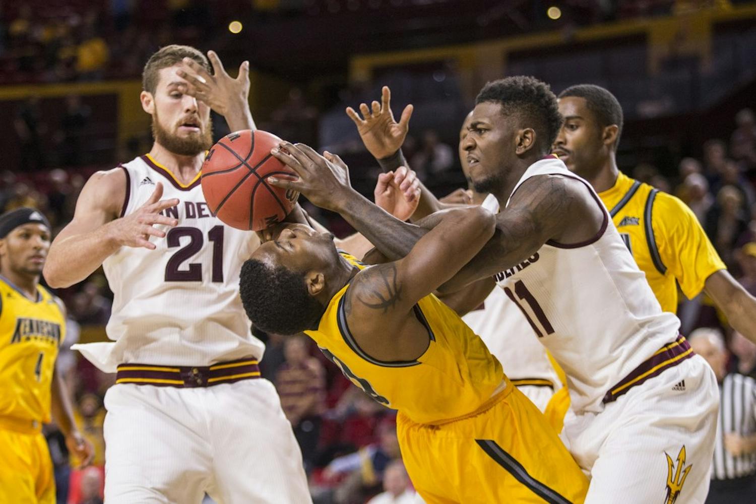 Junior forward Savon Goodman, right, fights for control of the ball in a game against Kennesaw State on Wednesday, Nov. 18, 2015, at Wells Fargo Arena in Tempe. The Sun Devils took down the Owls 91-53.