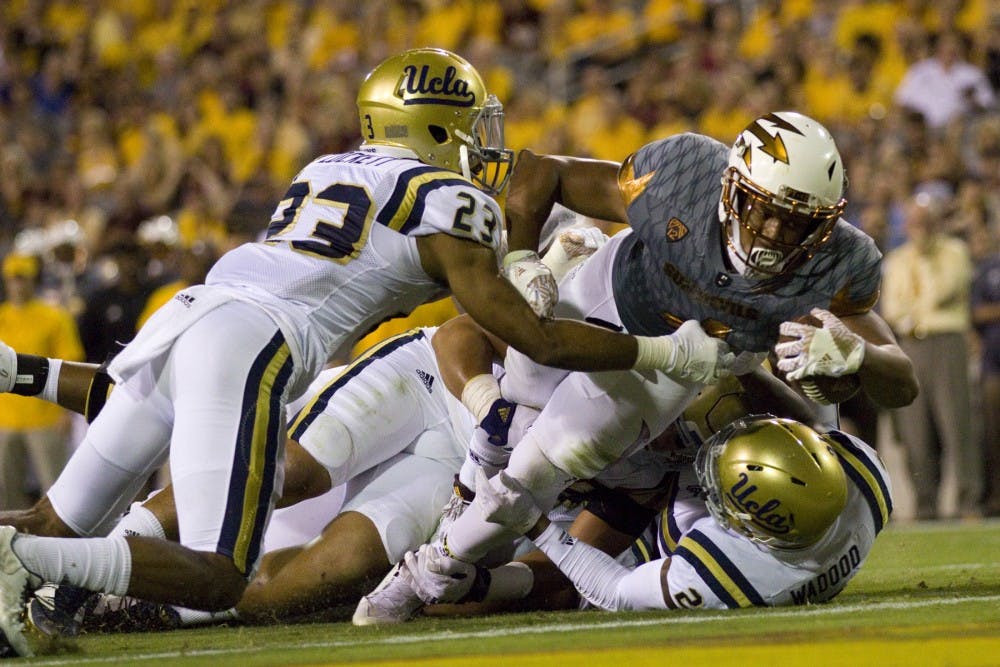 ASU junior running back Demario Richard (4) reaches out to cross the goalline to score a touchdown in the second half of the 23-20 victory over the UCLA Bruins in Sun Devil Stadium in Tempe, Arizona, on Saturday, Oct. 8, 2016.