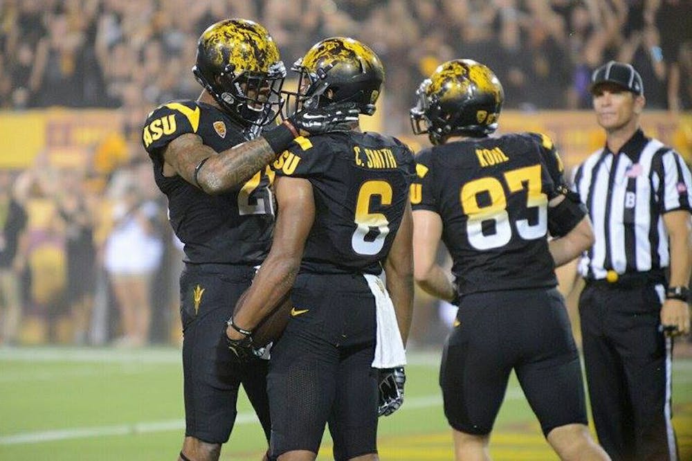 Redshirt junior receiver Jaelen Strong celebrates with sophomore receiver Cameron Smith after Smith caught a 29-yard pass from redshirt junior quarterback Mike Bercovici (Photo by Andrew Ybanez).