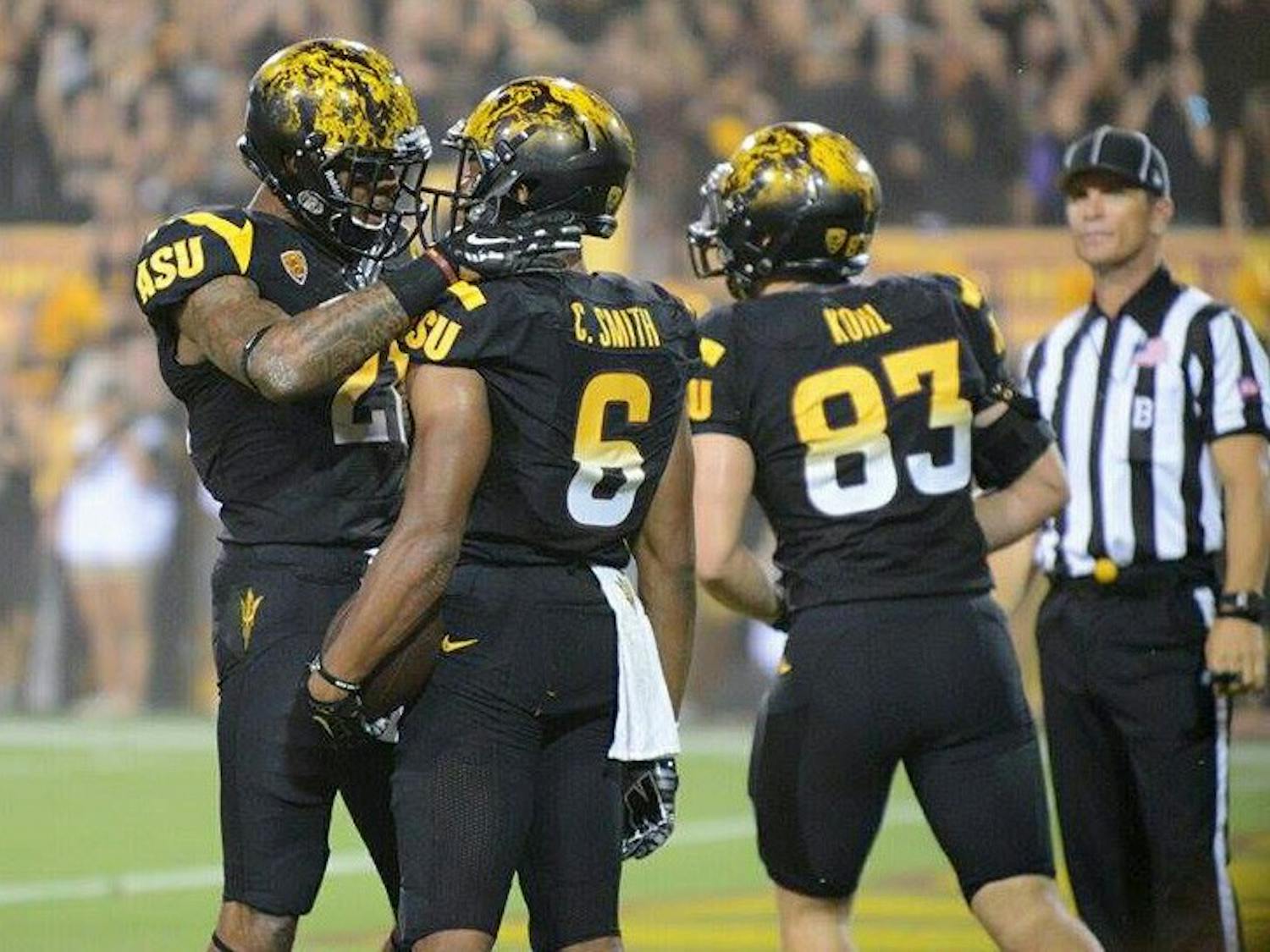 Redshirt junior receiver Jaelen Strong celebrates with sophomore receiver Cameron Smith after Smith caught a 29-yard pass from redshirt junior quarterback Mike Bercovici (Photo by Andrew Ybanez).