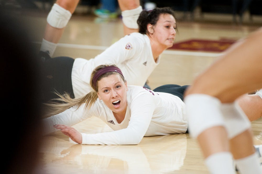 Freshman outside hitter Lexi MacLean (14) reacts after diving for the ball against Washington on Friday, Nov. 6, 2015, at Sun Devil Stadium in Tempe. The Huskies swept the Sun Devils 3-0.