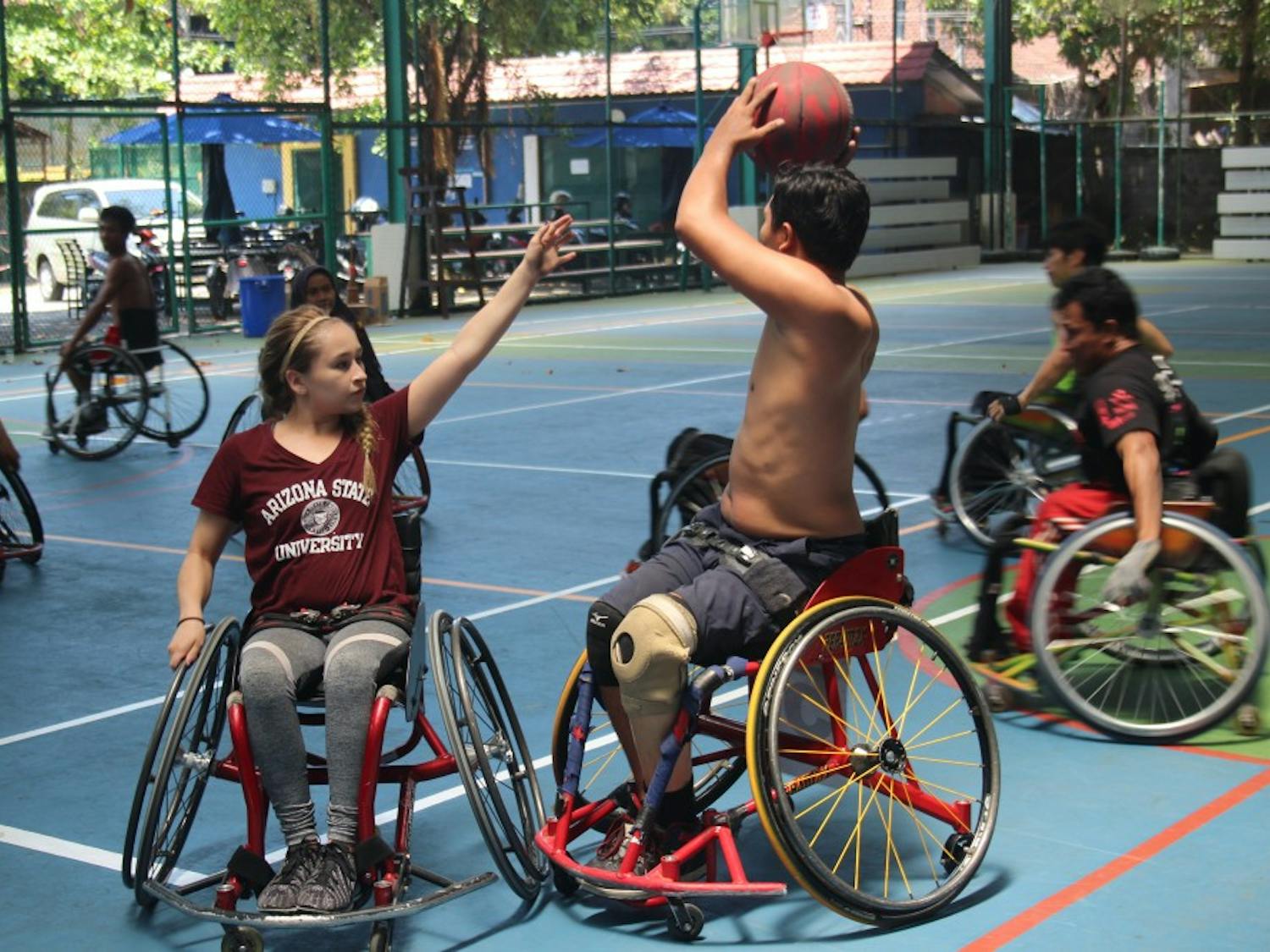 A group of players from a wheelchair basketball&nbsp;camp fight for control of the&nbsp;basketball.&nbsp;