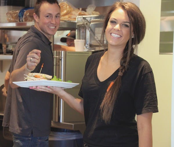 ORDER UP: ASU junior Camille Steffen, majoring in social work, and graduate Daniel Grover serve brunch at Mill Avenue's newest restaurant NCounter. (Photo by Rosie Gochnour)