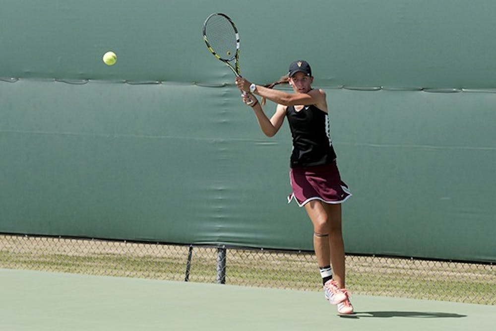 Sophomore Ebony Panoho returns the ball with a backhand in a match against Colorado on April 4. (Photo by Mario Mendez)