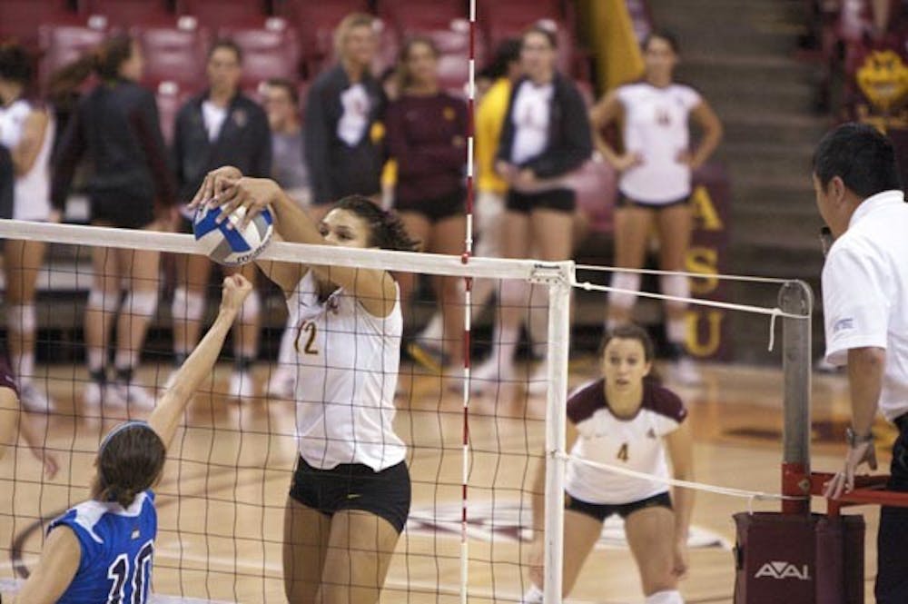 UP AND OVER: Senior outside hitter Sarah Reaves executes a block during a home match last weekend. The ASU women's volleyball team was back on the road over the weekend and split the series, topping Washington State before losing to Washington. (Photo by Scott Stuk)