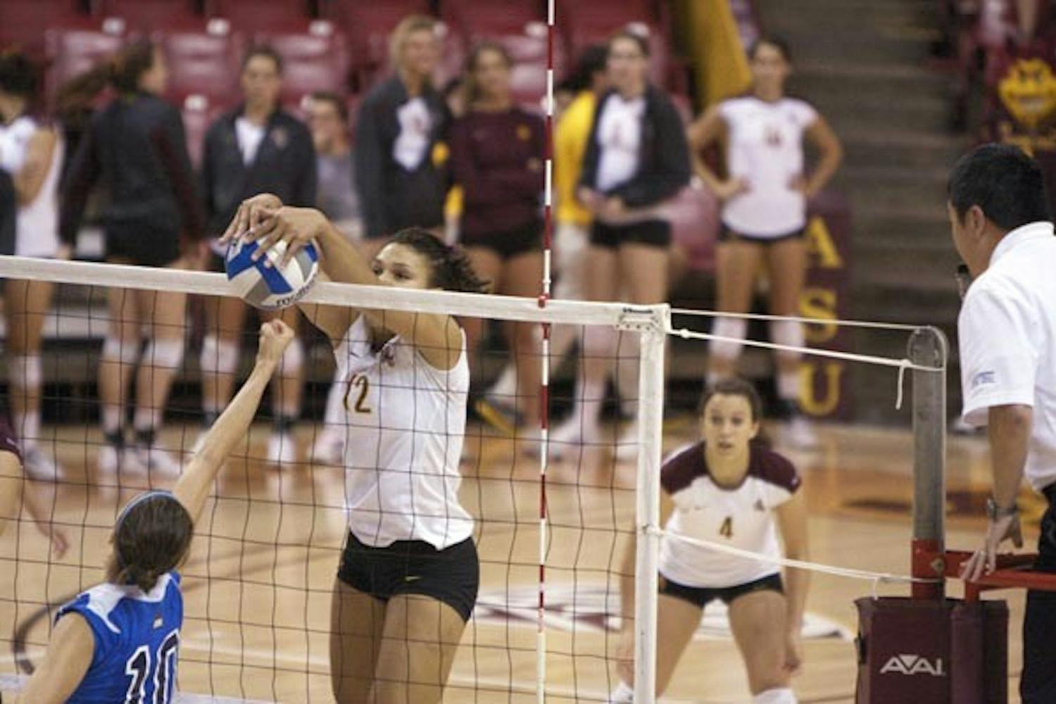 UP AND OVER: Senior outside hitter Sarah Reaves executes a block during a home match last weekend. The ASU women's volleyball team was back on the road over the weekend and split the series, topping Washington State before losing to Washington. (Photo by Scott Stuk)