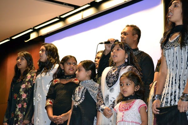 A family performs a song in their native costumes before the audience on International Mother Language Day. The presentation included singing and dancing and was done entirely in Bengali, the language of Bangladesh. (Photo by Mackenzie McCreary)