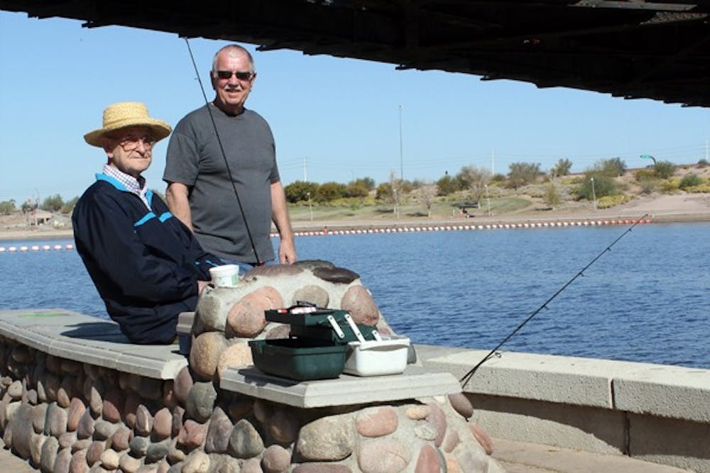 Eric Tiller (left) and Don Jeffcot (right) enjoy Tuesday's beautiful weather as they fish at Tempe Town Lake. A recent survey by the City of Tempe said that residents's satisfaction is 33 percent higher than the national average. (Photo by Adrian Juarez)