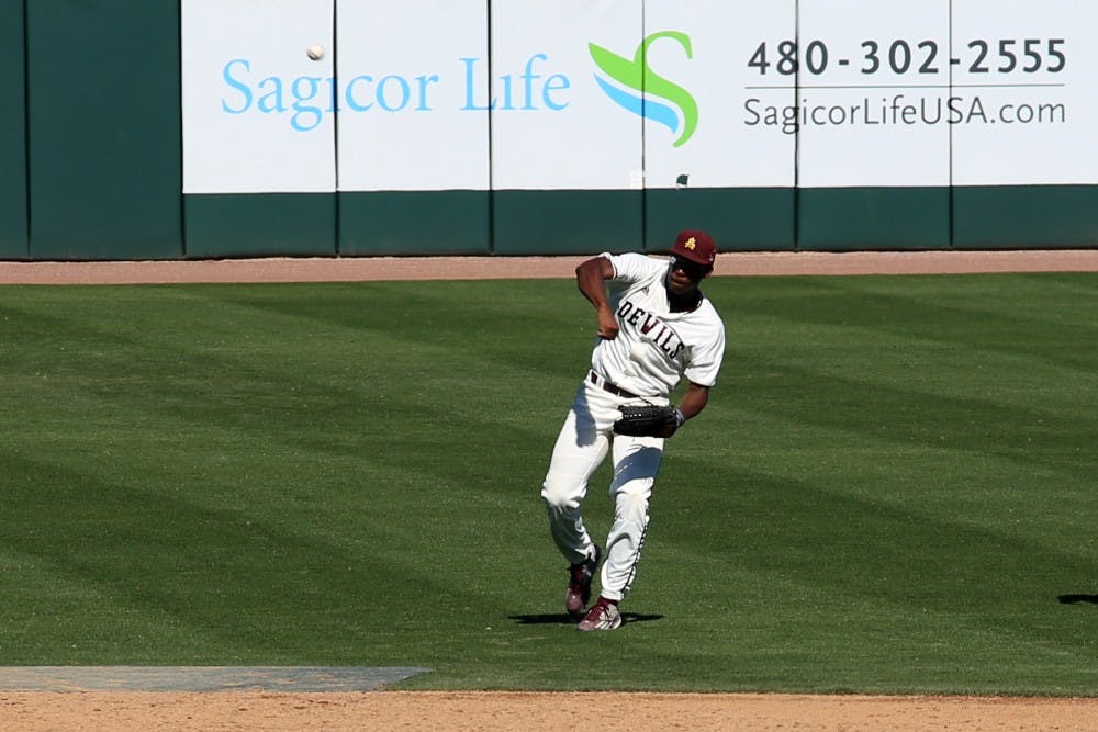 Junior outfielder Daniel Williams (31) returns the ball to the infield after catching a pop-fly during the Maroon and Gold scrimmage on Saturday, Feb. 13, 2016, in the Phoenix Municipal Stadium.