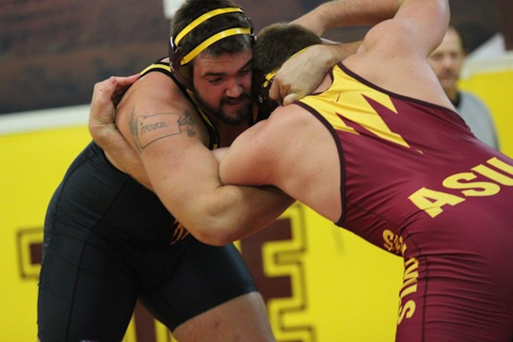 Redshirt senior 285-pound wrestler Levi Cooper contains teammate and freshman Luke Bean during the Sun Devils’ Maroon and Gold Wrestle-Offs on Oct. 26. (Photo by Kyle Newman)