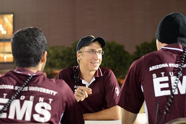 Jacob Anderson jokes with some other student EMTs on the SDFC fields during intramural flag football on Thursday, Oct. 23, 2014. Anderson is a senior and studying psychology. (Photo by Jonathan Williams)