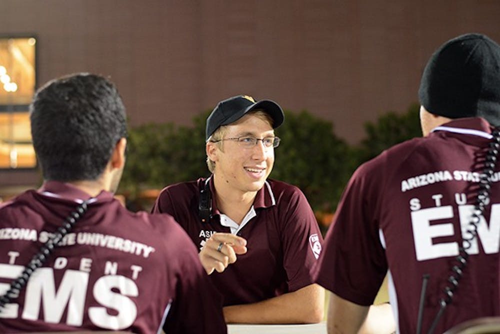 Jacob Anderson jokes with some other student EMTs on the SDFC fields during intramural flag football on Thursday, Oct. 23, 2014. Anderson is a senior and studying psychology. (Photo by Jonathan Williams)