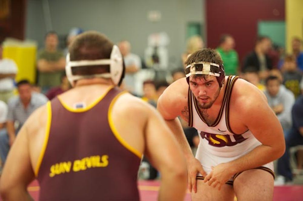 PIN PURSUIT: Redshirt sophomore Levi Cooper gets set for a match during Sun Devil Wrestle-Offs earlier this season. Over the weekend, the ASU wrestling squad won two duals, topping Grand Canyon and Embry-Riddle on Saturday. (Photo by Michael Arellano)