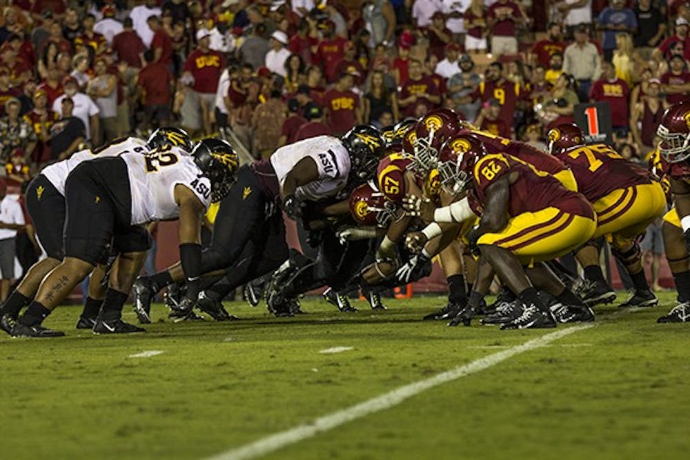 ASU's defensive line pushes against USC's offensive line in a game on Oct. 4, 2014 in Los Angeles. ASU won against USC 38-34. (Photo by Alexis Macklin)