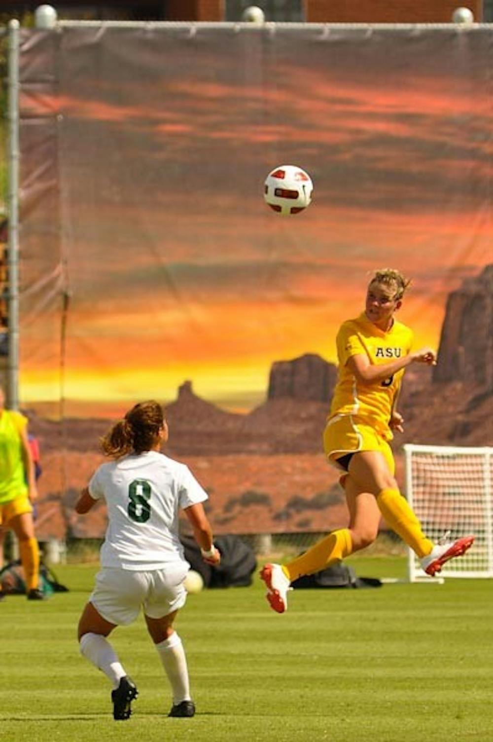 HEAD GAME: Freshman forward Devin Marshall finishes a header in a recent game against Baylor. The 3-0-1 women's soccer team plays two games and hosts the Sun Devils Classic this weekend. (Photo by Aaron Lavinsky)