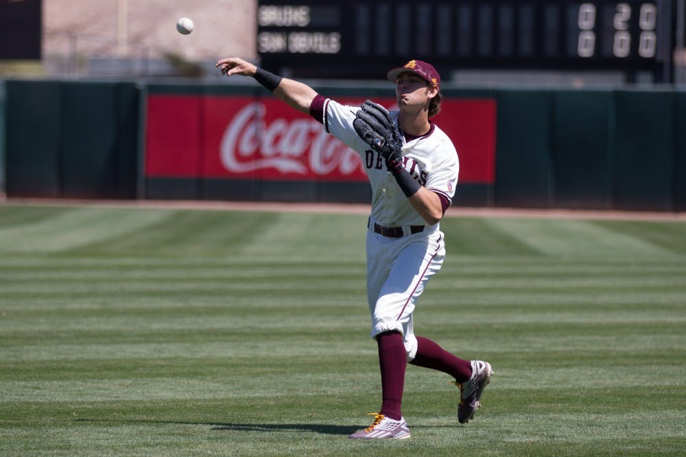 ASU junior infielder Andrew Snow (4) catches the relay and throws the ball to the plate during game three of a baseball series against the UCLA Bruins at Phoenix Municipal Stadium in Phoenix on April 2, 2017.