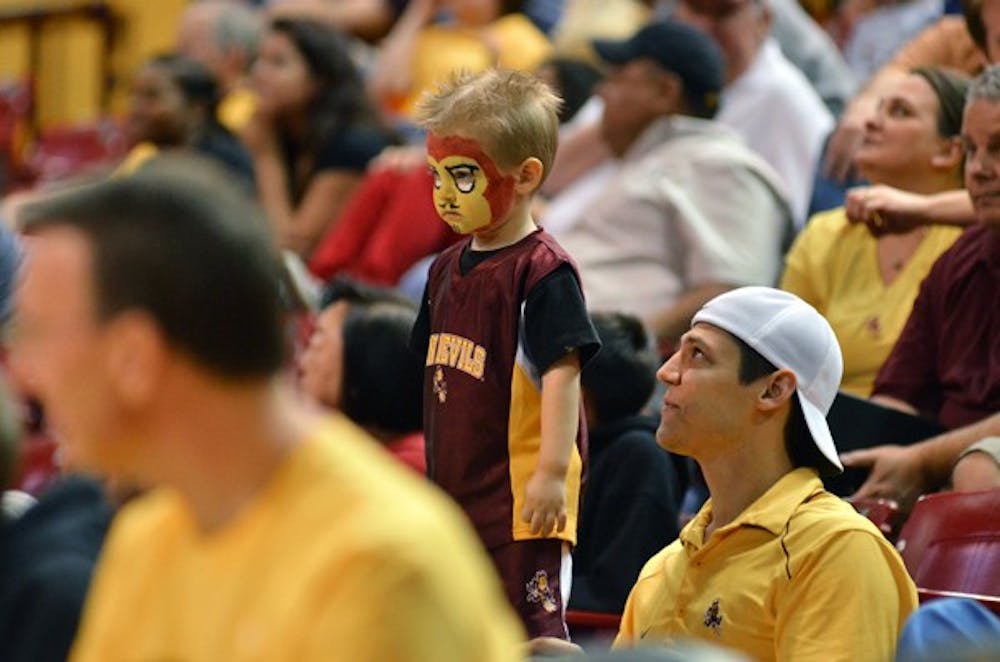 A look of disappointment haunts a little Sun Devil fan’s face during the ASU men's basketball game against USC Feb. 25. (Photo by Aaron Lavinsky)