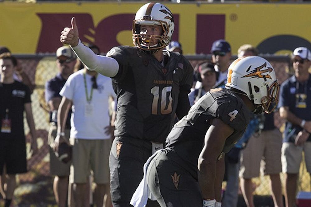 Redshirt senior quarterback Taylor Kelly gives a thumbs up to the ASU sideline in a home game against Notre Dame on Saturday, Nov. 8, 2014. ASU won against Notre Dame 55-31. (Photo by Alexis Macklin)