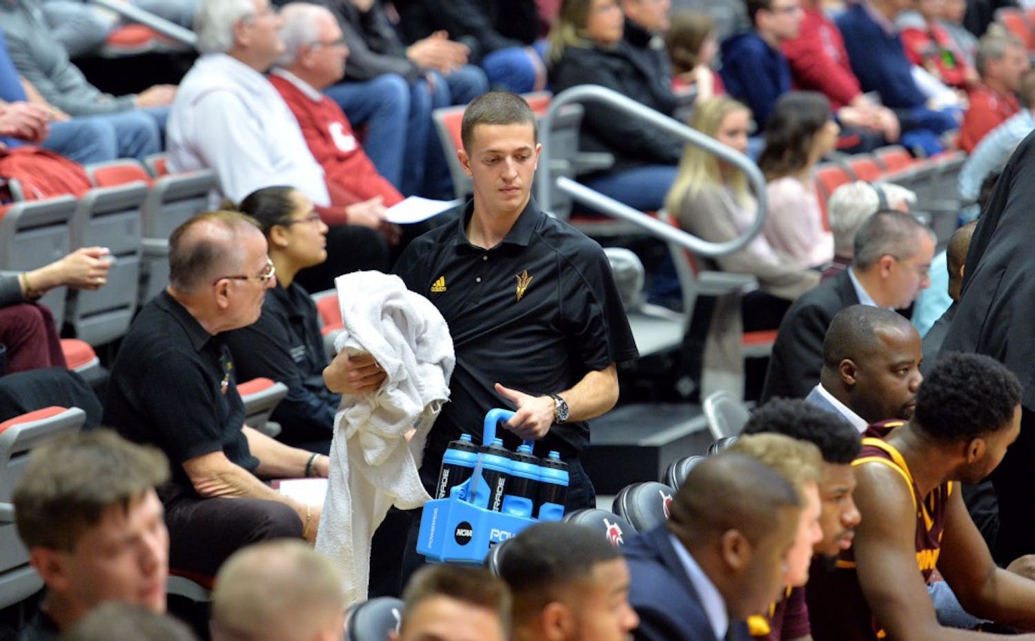 ASU men's&nbsp;basketball manager Scott Geerling carries water for players at a game against WSU at Beasley Coliseum in Pullman, Washington on Feb. 18, 2017.