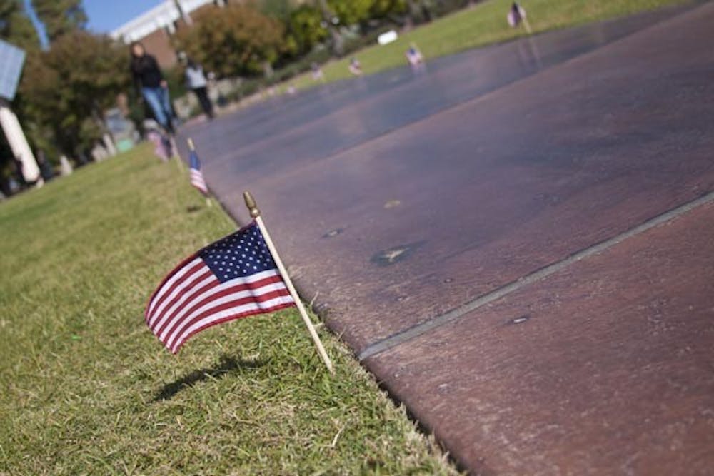 HONORING VETERANS: Hundreds of American flags line the walkways on campus in remembrance of Veteran's Day today. (Photo by Annie Wechter)