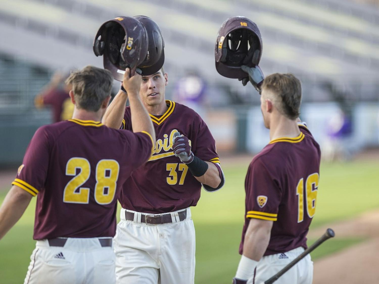 ASU shortstop Cody Woodmansee, center, celebrates with teammates after hitting a home-run during a game against the University of Washington Huskies at Phoenix Municipal Stadium in Phoenix, Arizona, on Saturday, April 9, 2016. The Sun Devils won the game, 6-3. 
