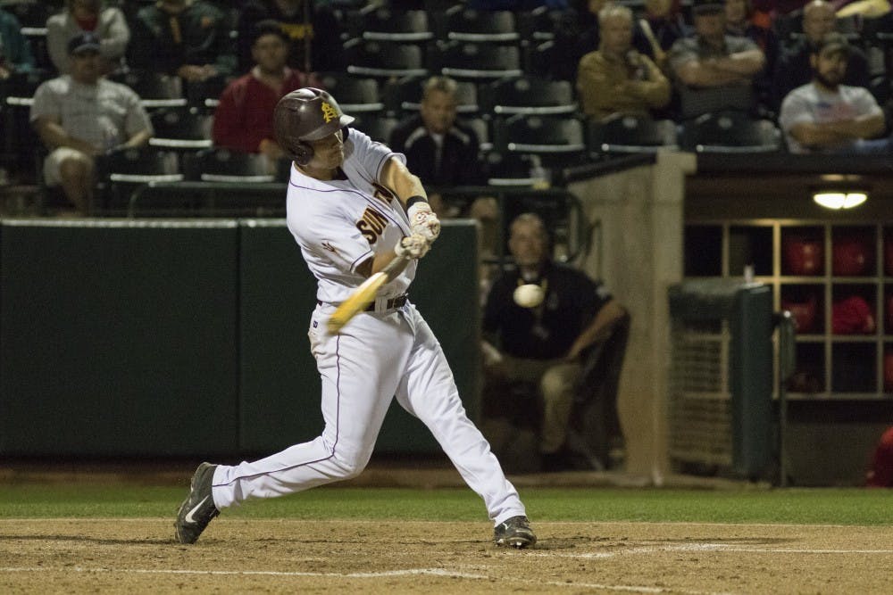 Senior Joey Bielek hits an RBI single to score Sophomore Brian Serven in the bottom of the second inning against University of New Mexico at Phoenix Municipal Stadium on Wednesday March 18, 2015. The Sun Devils defeated the Lobos 4-3. (Jacob Stanek/ The State Press)