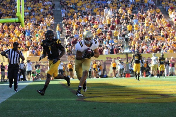 Redshirt senior cornerback Deveron Carr watches as UCLA redshirt senior tight end Joseph Fauria hauls in a touchdown pass during the Sun Devils’ 45-43 loss to the Bruins on Saturday. (Photo by Kyle Newman)