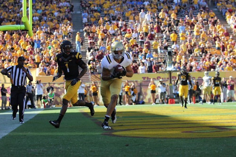 Redshirt senior cornerback Deveron Carr watches as UCLA redshirt senior tight end Joseph Fauria hauls in a touchdown pass during the Sun Devils’ 45-43 loss to the Bruins on Saturday. (Photo by Kyle Newman)