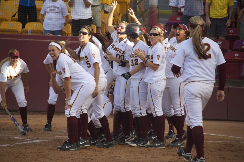 The Sun Devils gather to celebrate a home run from junior Haley Steele during game two of the NCAA Tempe Regional Championships against the Michigan Wolverines on Sunday, May 18, at Farrington Stadium. ASU lost to Michigan 4-5. (Photo by Becca Smouse)
