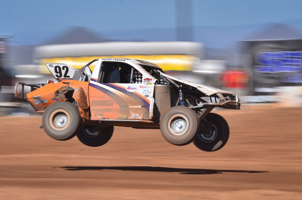Jacob Person's truck flies through the air (Photo by Aaron Lavinsky)