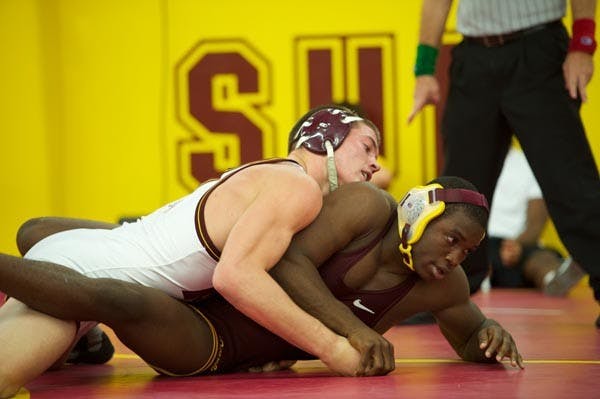 TOP POSITION: Junior Jake Meredith grapples with freshman Kevin Radford during Friday's Wrestle-Offs. Meredith defeated Radford for the starting spot in the 184-pound weight class. (Photo by Michael Arellano)