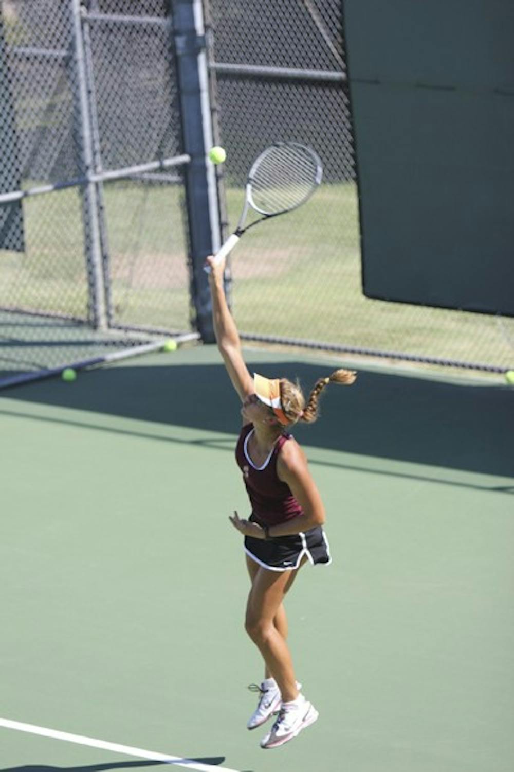 Junior Jacqueline Cako serves the ball in practice last week prior to the Wolverine Invitational. (Photo by Kyle Newman)