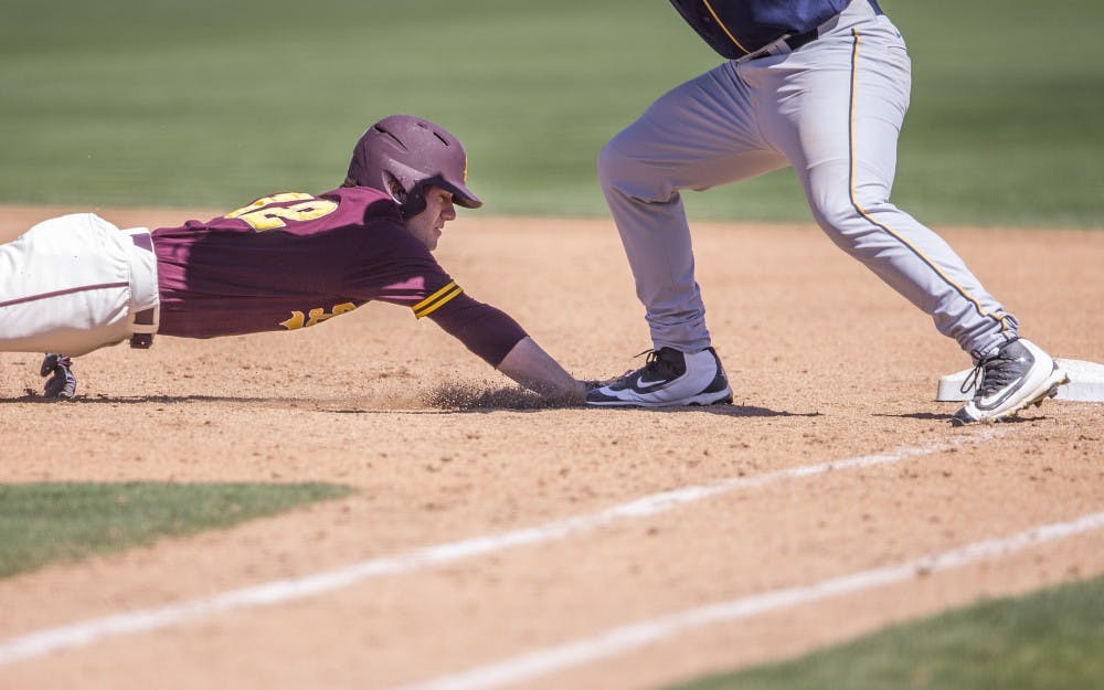ASU baseball's Gage Canning dives back towards first base during a game against California at Phoenix Municipal Stadium in Phoenix, Arizona, on Saturday, April 16, 2016. 