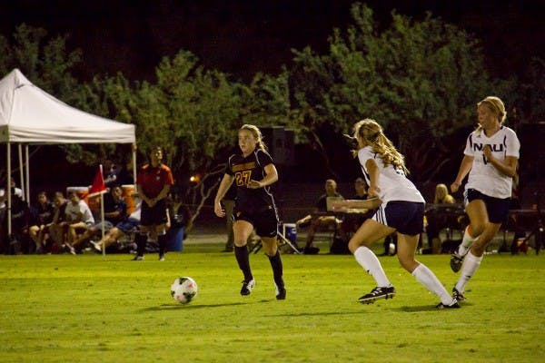 Sophomore forward Aly Moon dribbles the ball around her opponent in a home scrimmage against NAU on Aug. 15. 