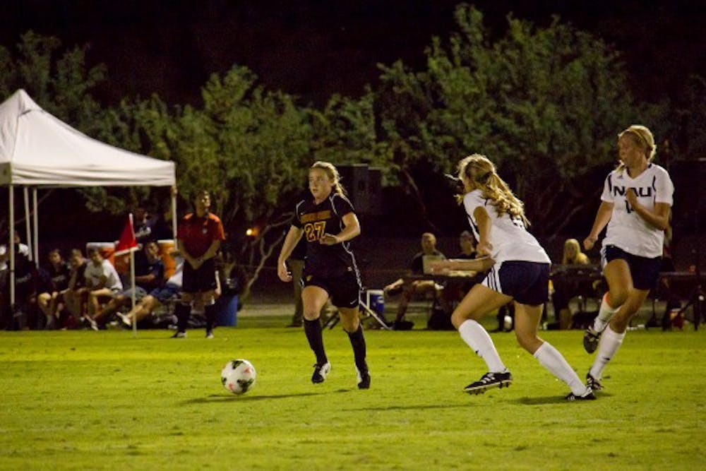 Sophomore forward Aly Moon dribbles the ball around her opponent in a home scrimmage against NAU on Aug. 15. 