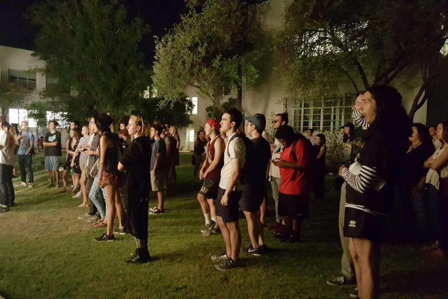 Students watch the Underground Foundation performance in the Tempe Secret Garden on Thursday, August 25. 