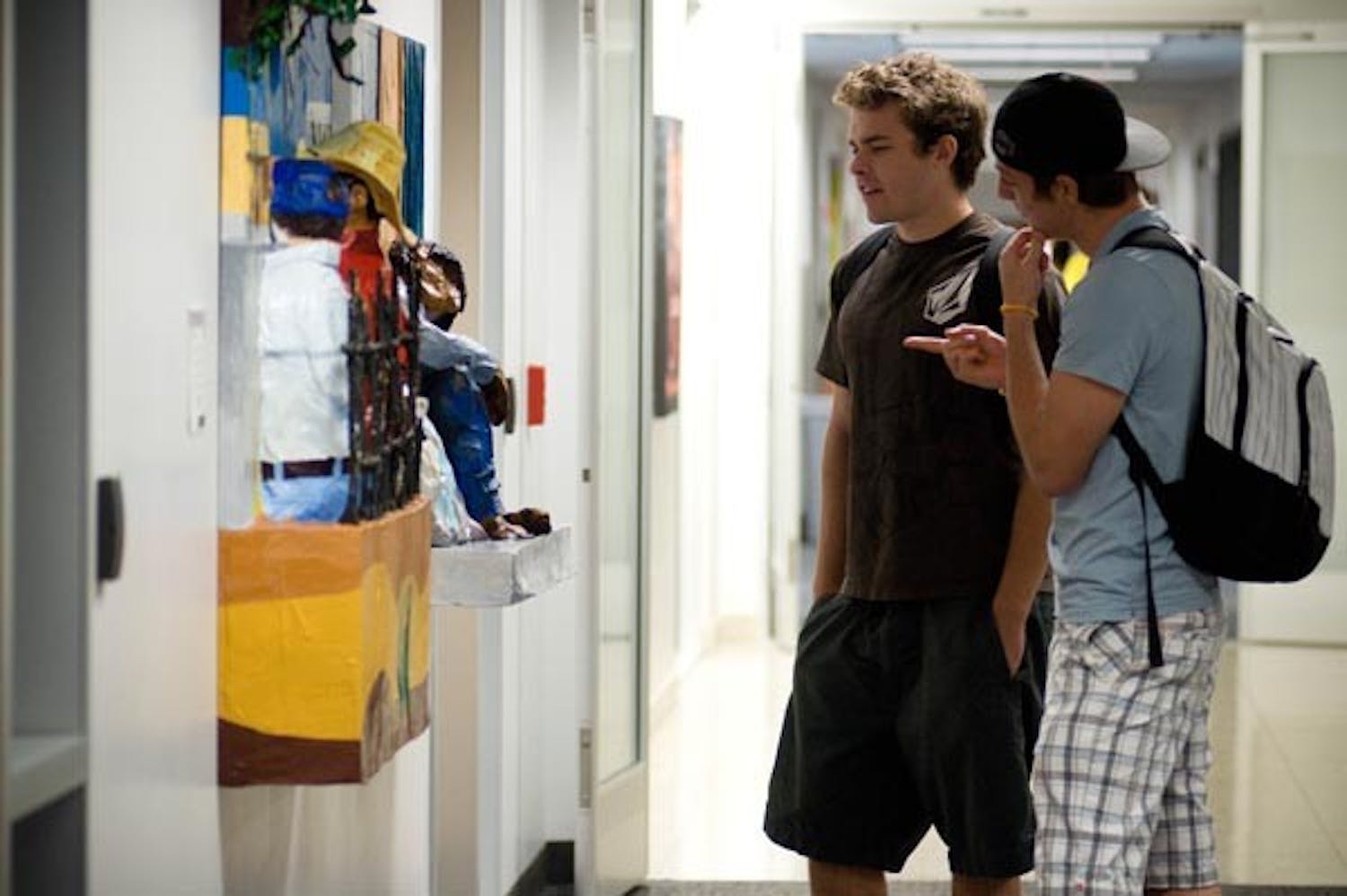 ART ENTHUSISTS: Print Journalism junior Blake Higgins and Broadcast sophomore Collin Flemming check out some of the 3-D art at the University Center building on the Downtown campus. (Photo by Aaron Lavinsky)