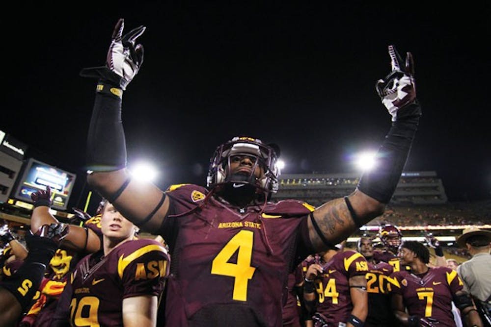 Junior safety Alden Darby raises two pitchfork signs in celebration of the Sun Devils’ 45-14 win over Illinois on Saturday. (Photo by Sam Rosenbaum)