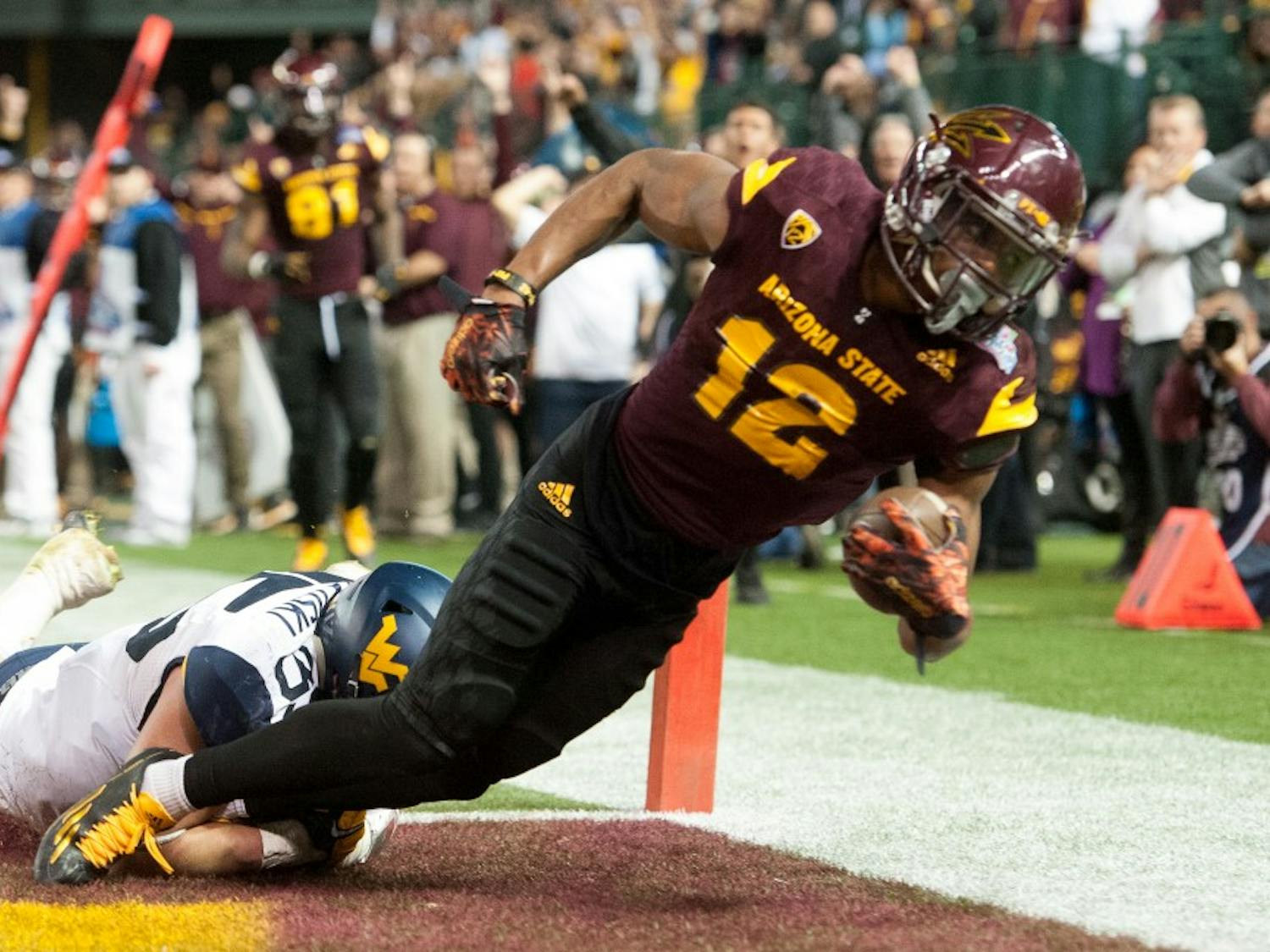 Redshirt junior wide receiver Tim White (12) scores a touchdown against West Virginia during the Motel 6 Cactus Bowl on Saturday, Jan. 2, 2016, at Chase Field in Phoenix.