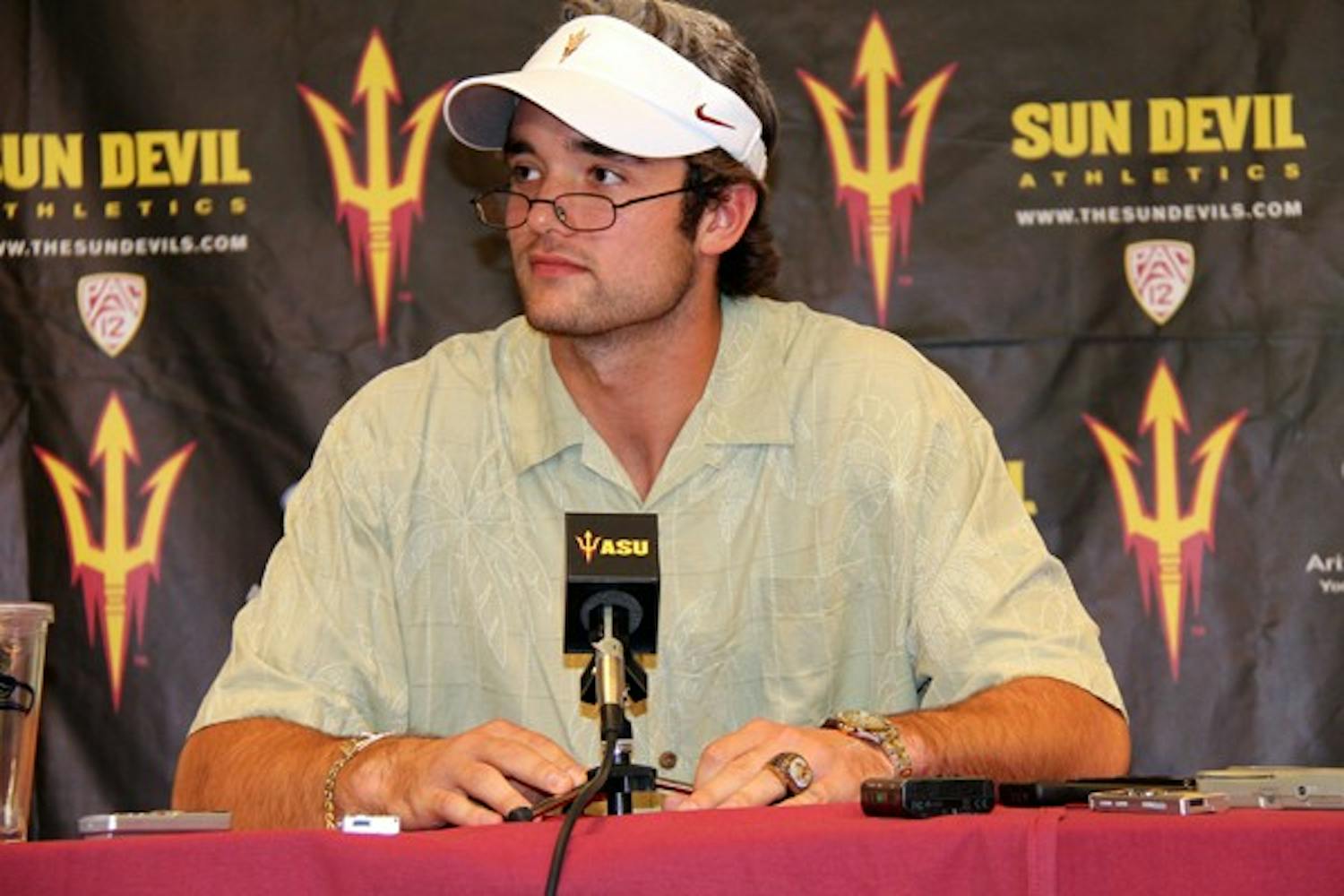 ALL DRESSED UP: ASU junior quarterback Brock Osweiler answers questions at Monday’s press conference dressed up as coach Dennis Erickson, all the way down to the white hair, visor and championship ring. (Photo courtesy of Maggie Emmons)