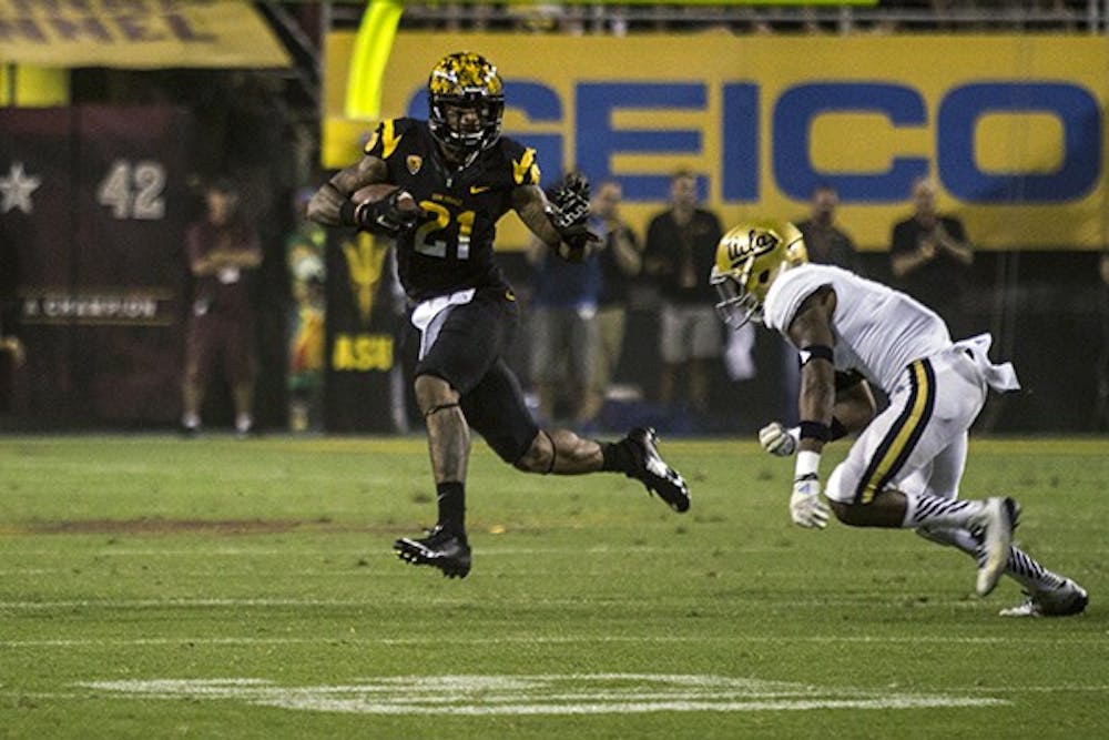 Redshirt junior wide receiver Jaelen Strong attempts to avoid an oncoming defender in home game against UCLA on Sept. 25, 2014. The Sun Devils lost to the Bruins, 62-27. (Photo by Alexis Macklin)