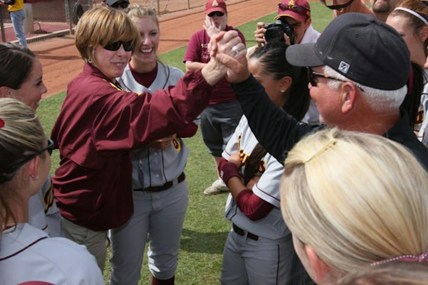 Jeffrey Lowman/The State PressSUPPORT FROM THE HIGHER-UPS: ASU athletic director Lisa Love high-fives ASU softball head coach Clint Meyers after the 9-0 victory over the Northwestern Wildcats that May 24th at Farrington Stadium that sent ASU to the Softball World Series in Oklahoma City.