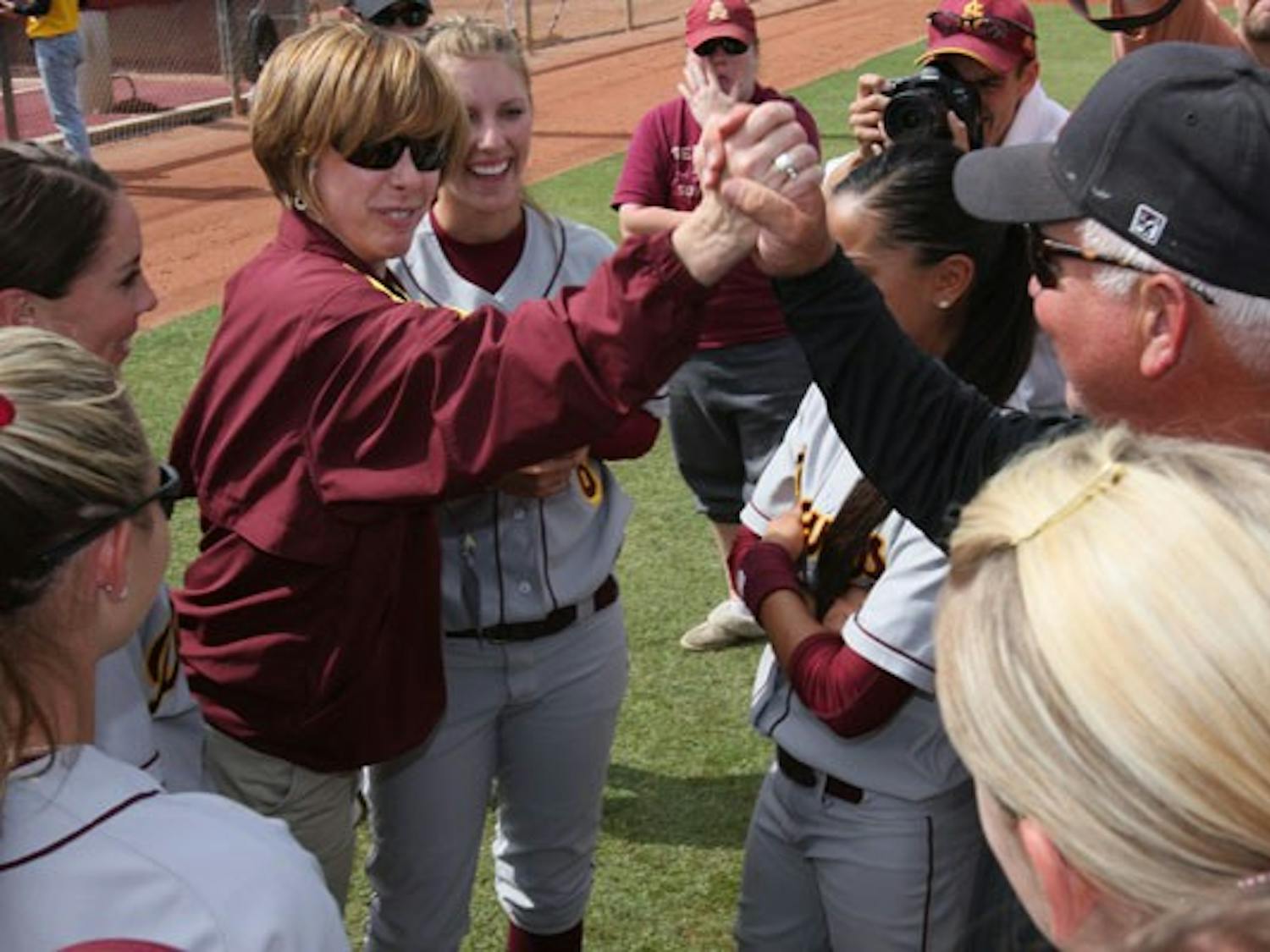 Jeffrey Lowman/The State PressSUPPORT FROM THE HIGHER-UPS: ASU athletic director Lisa Love high-fives ASU softball head coach Clint Meyers after the 9-0 victory over the Northwestern Wildcats that May 24th at Farrington Stadium that sent ASU to the Softball World Series in Oklahoma City.