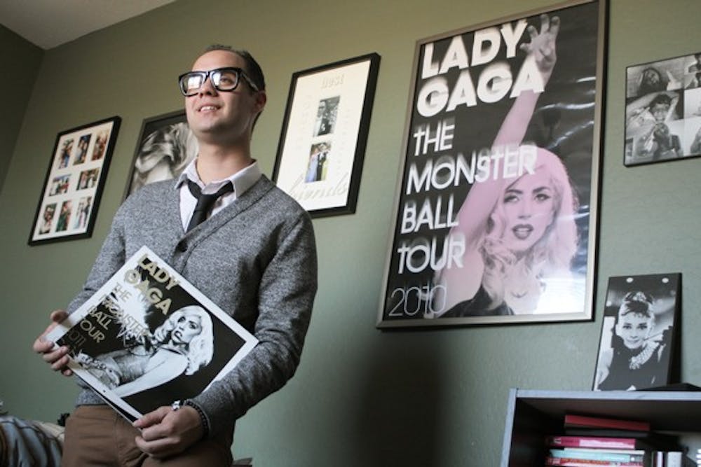 Journalism junior Robert Soares has been a fan of Lady Gaga since his junior year of high school. Pictured here in his room, Soares has multiple Gaga posters and CDs. (Photo by Sean Logan)