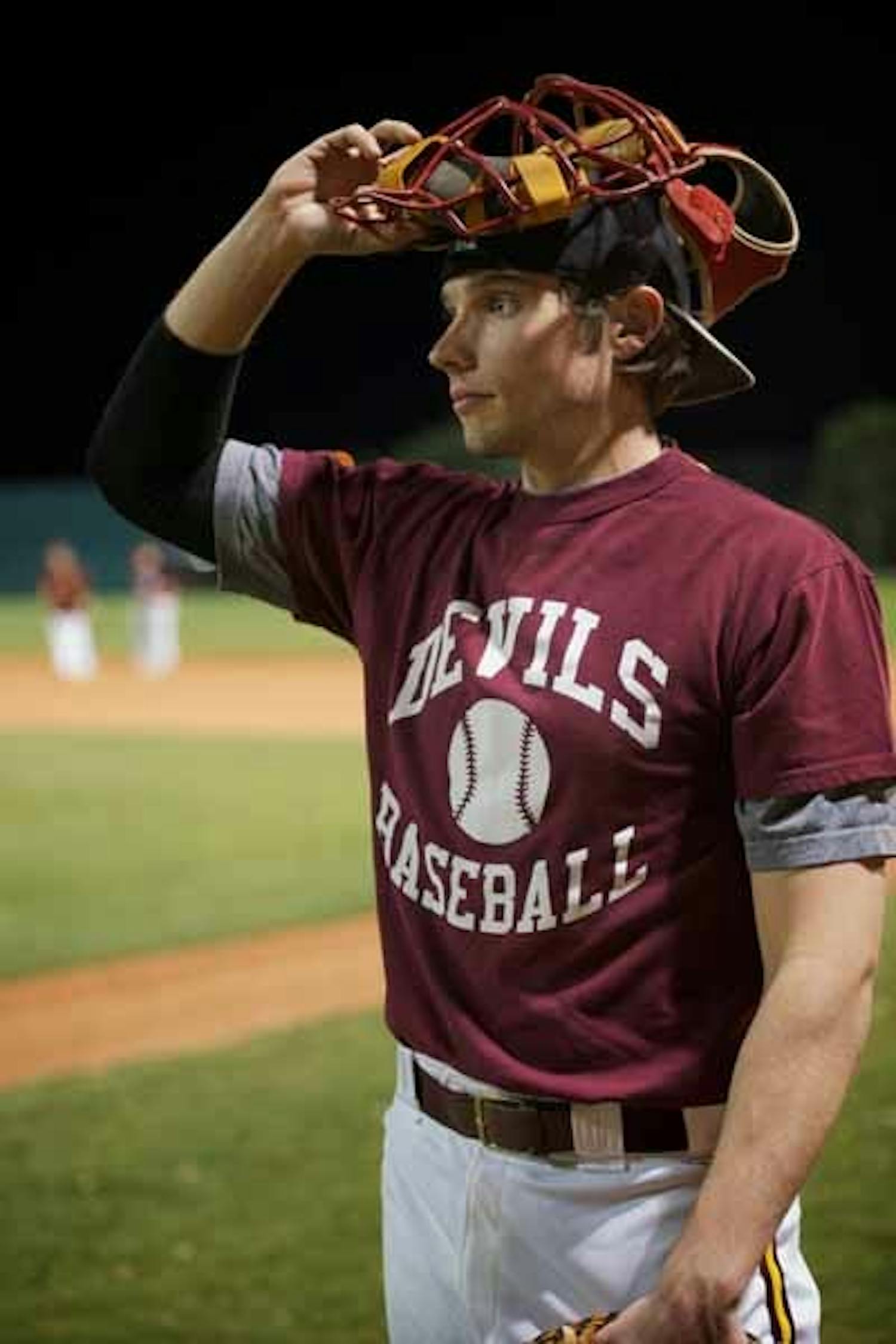 PREPERATION: Senior catcher Nick Morreale takes a break during the ASU club baseball team’s practice Tuesday night. The Sun Devils are working to mix new talent in with their already-experienced roster. (Photo by Michael Arellano)